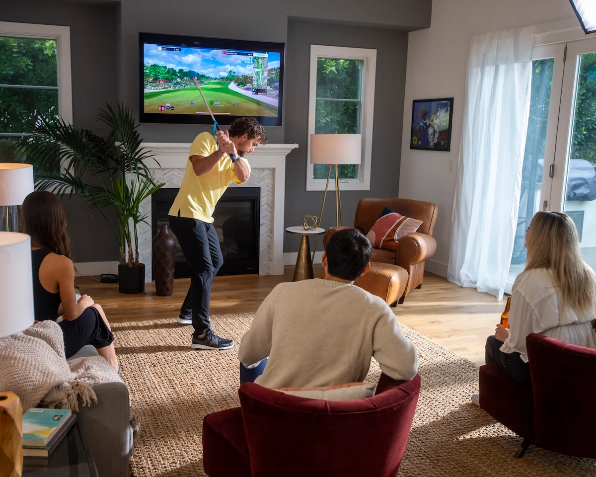 Friends using Phigolf simulator at party