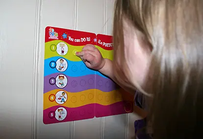 Child applying a sticker reward