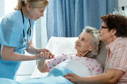 Hospice nurse with patient and family member