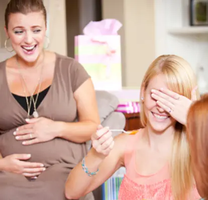 Women playing baby shower game
