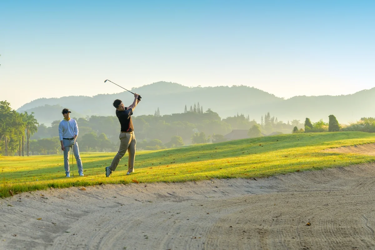 golfer hits shot from the rough