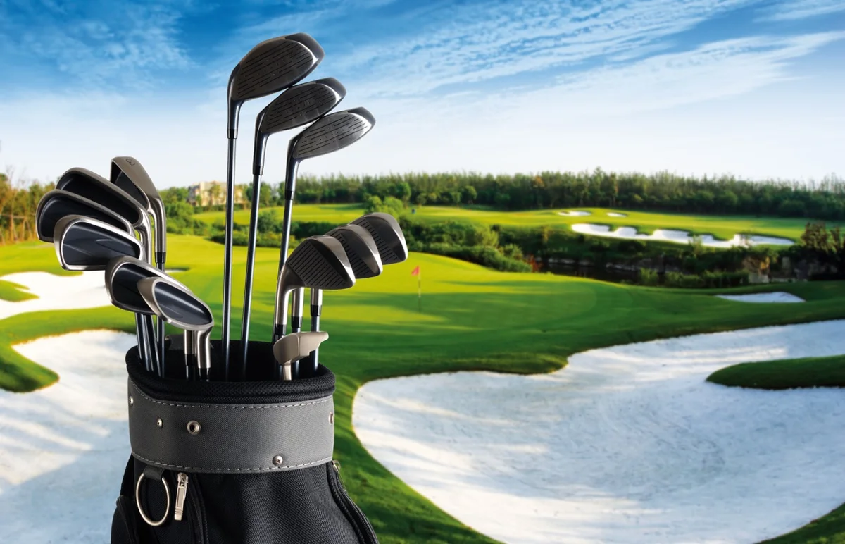Golf club set with fairway in background