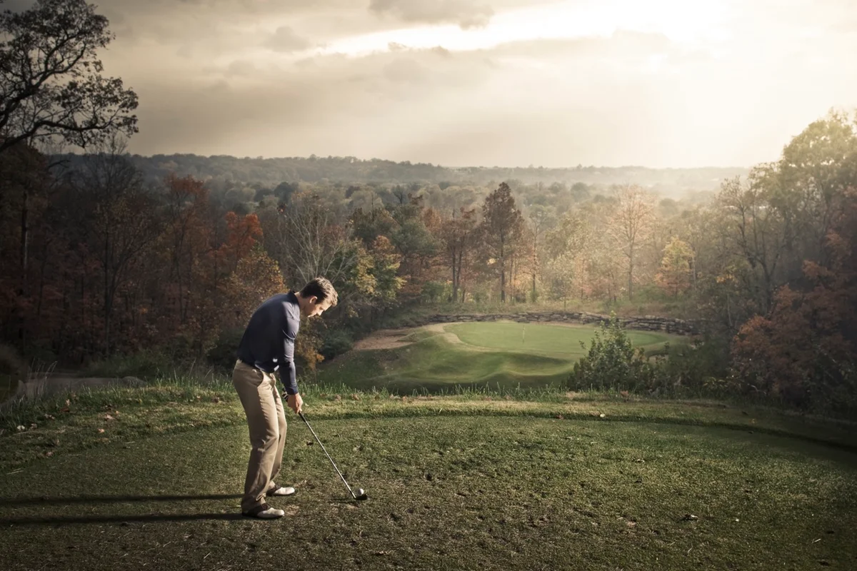 golfer prepares to hit a shot