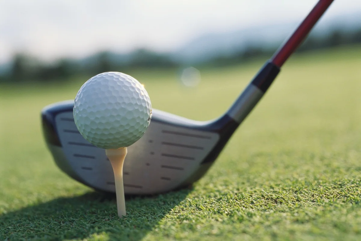 Golf driver at address with ball on tee