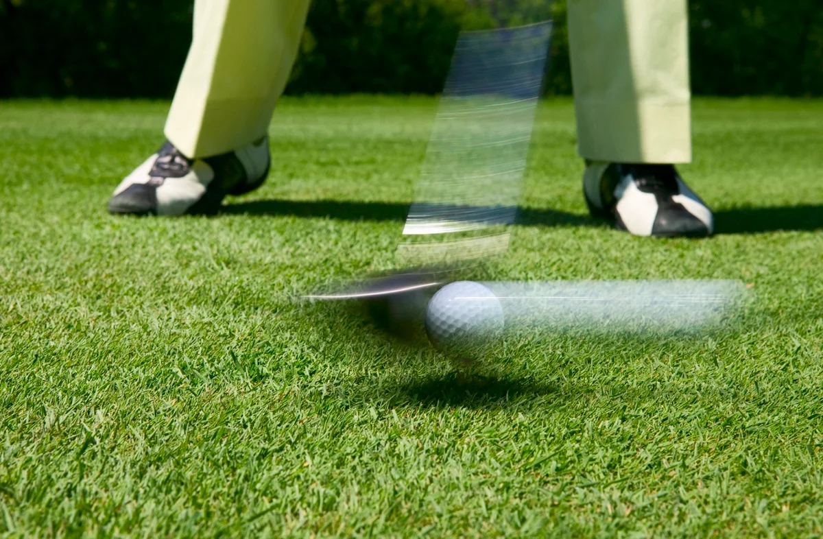 Golfer makes impact with a driver