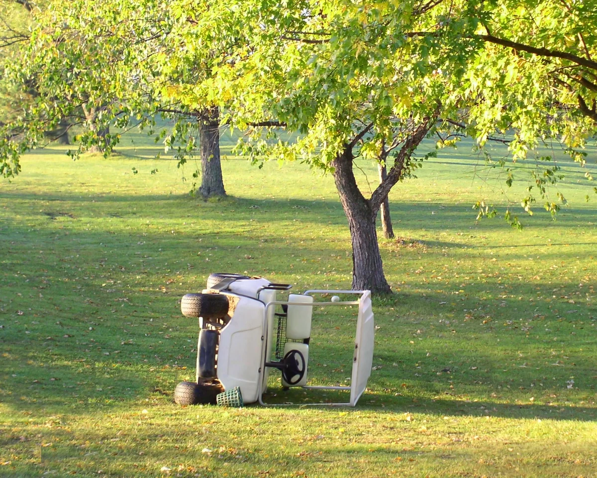 broken golf cart on course