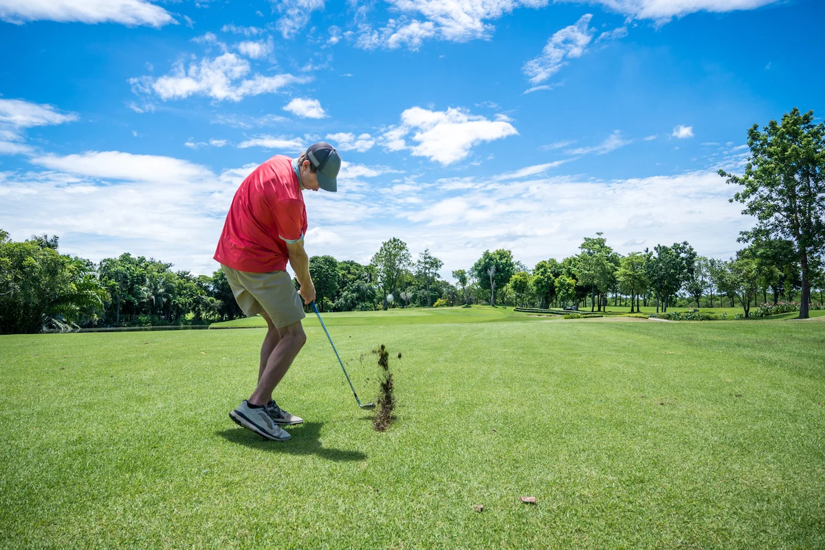 golf iron shot with divot