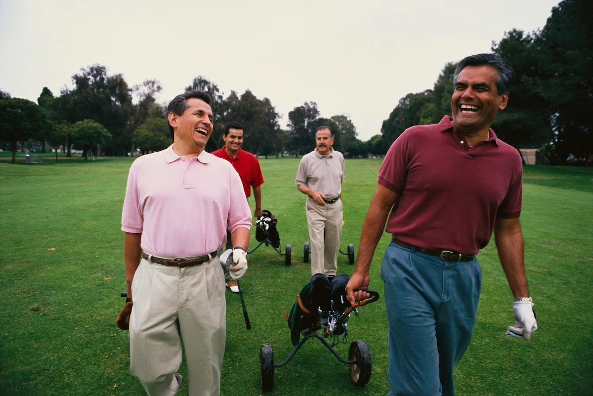 group of golfers walking on course