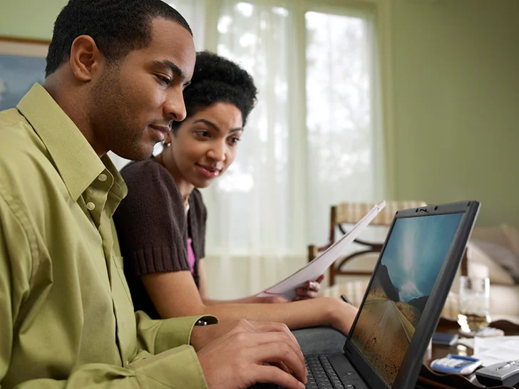 People looking at a computer
