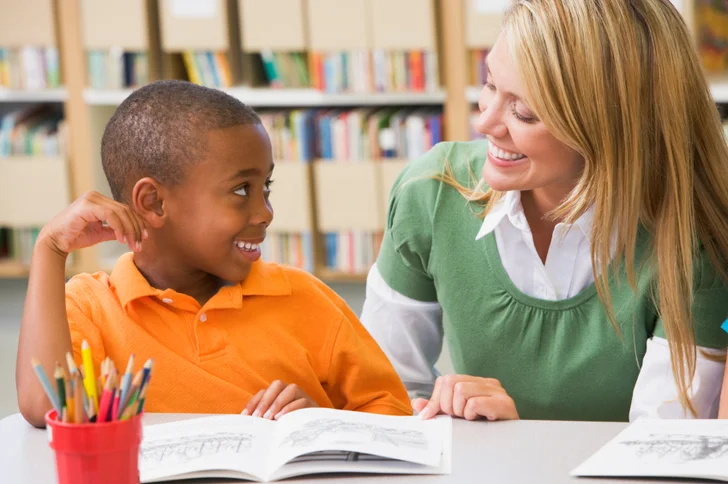 Volunteer teaching child to read