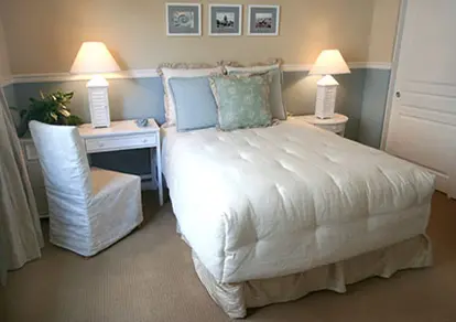 Bedroom appears larger with nightstand and small desk combo