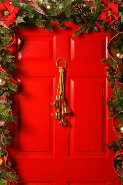 Red door with garland and bells