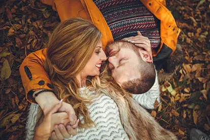 Couple on ground in leaves