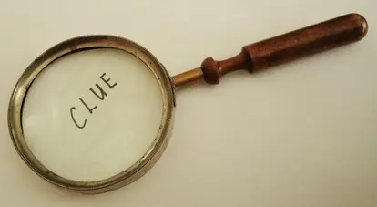 magnifying glass with clue