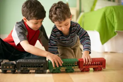 Boys playing with train