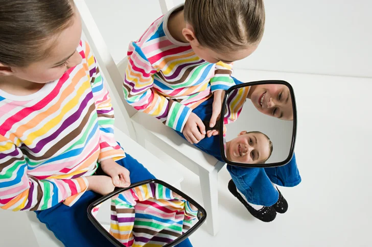 twin girls with mirrors
