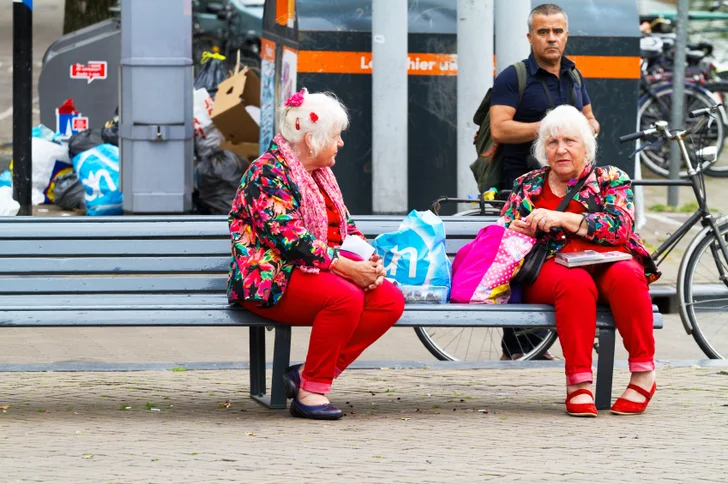 mature twins sitting on bench