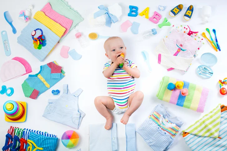 Little baby with infant care items