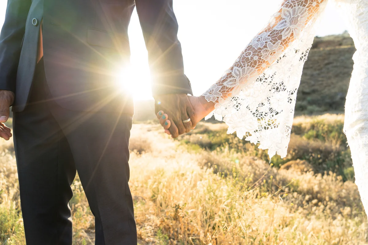 Couple holding hands at wedding