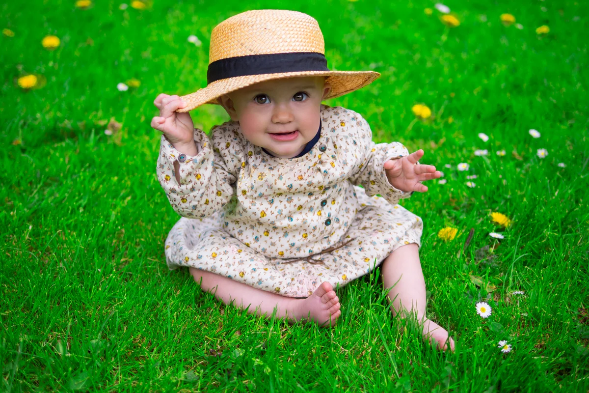 baby in sun hat and dress