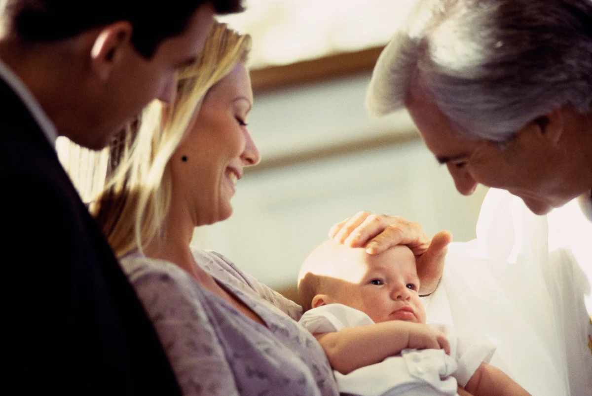 Priest blessing a baby