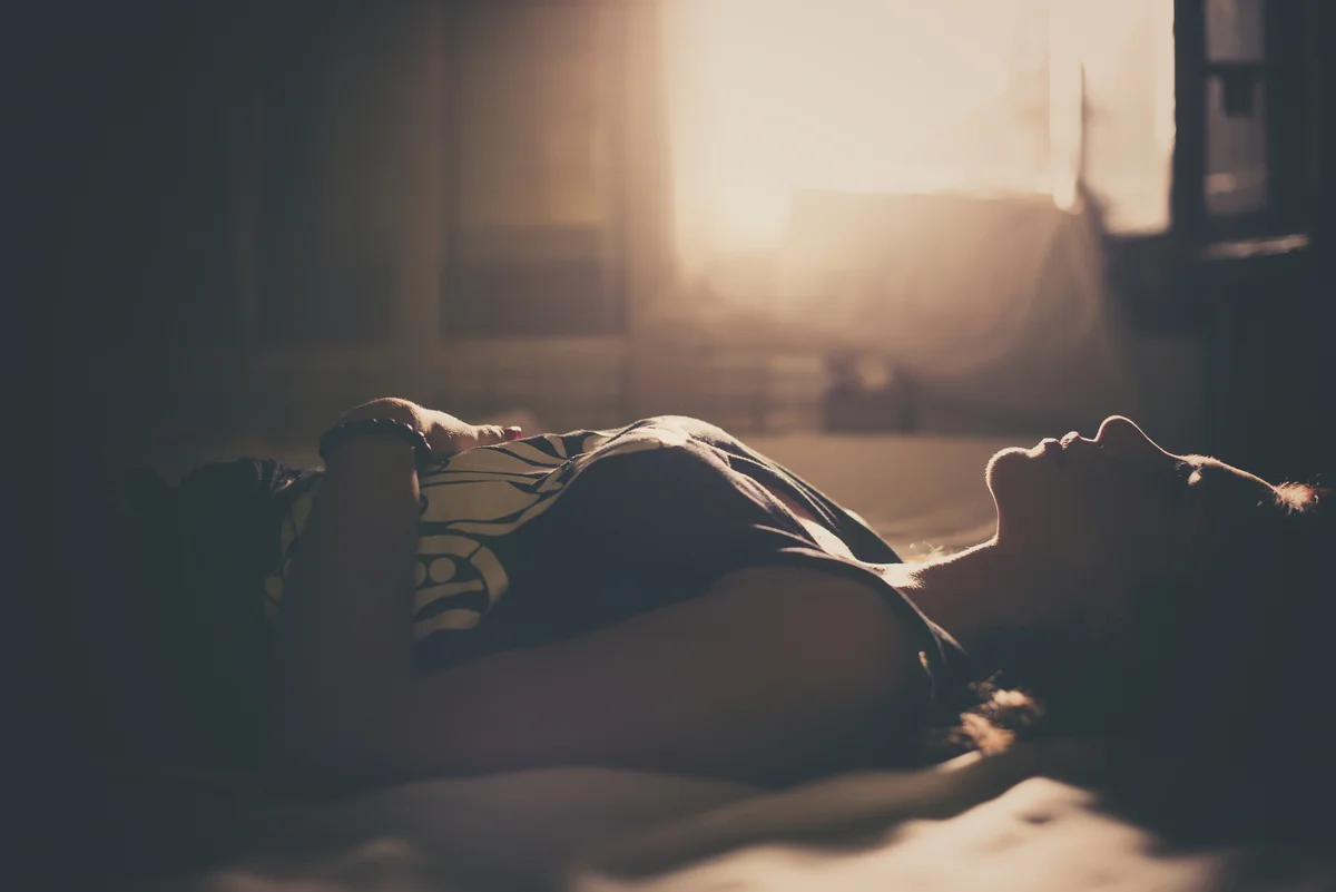 sad girl laying on bed