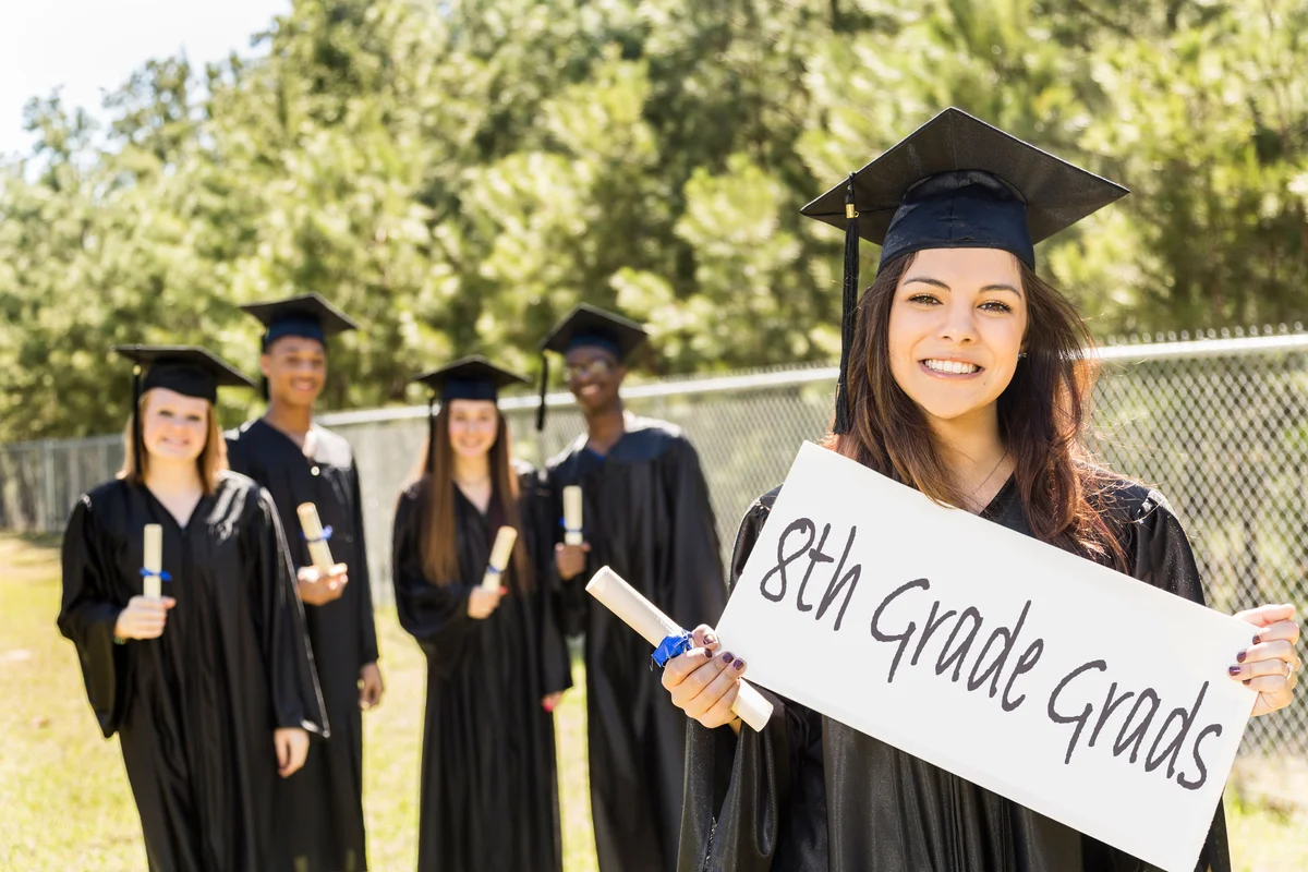 Students holding sign