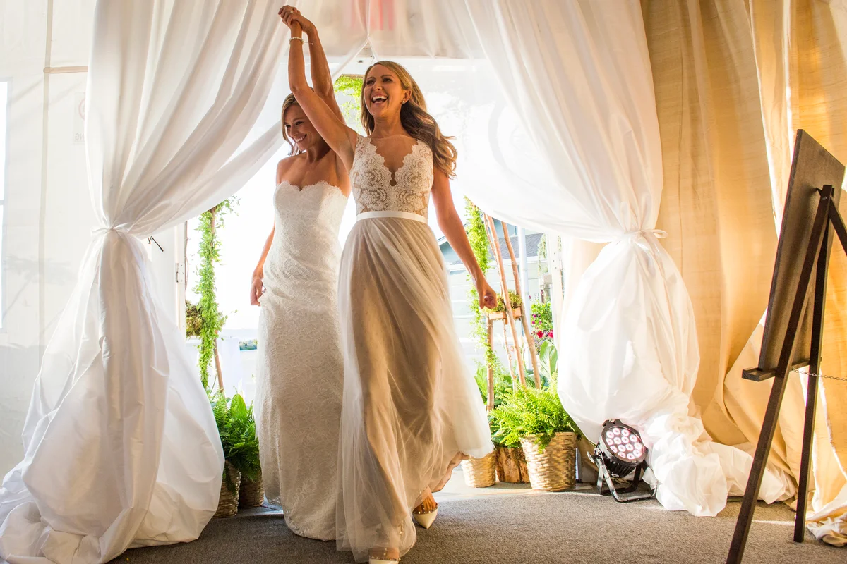 Brides walking through curtain