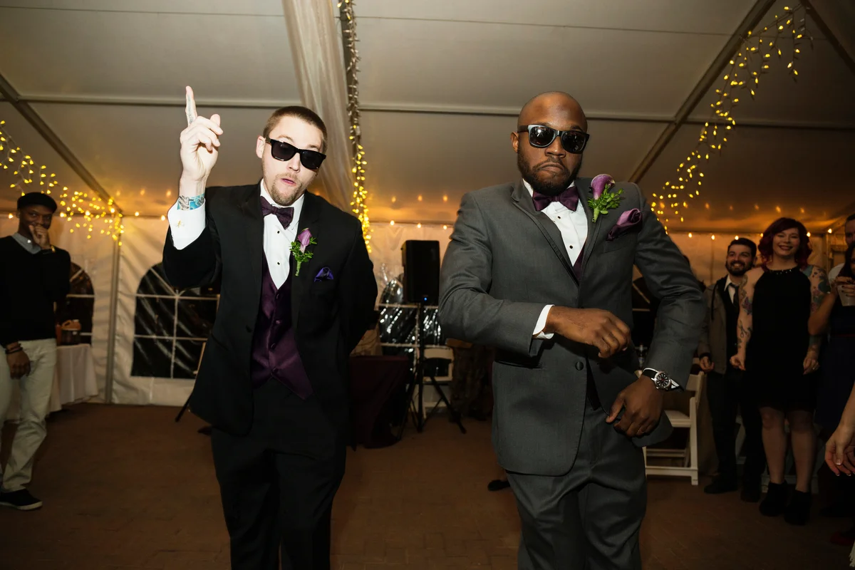 Groom and groomsman dancing