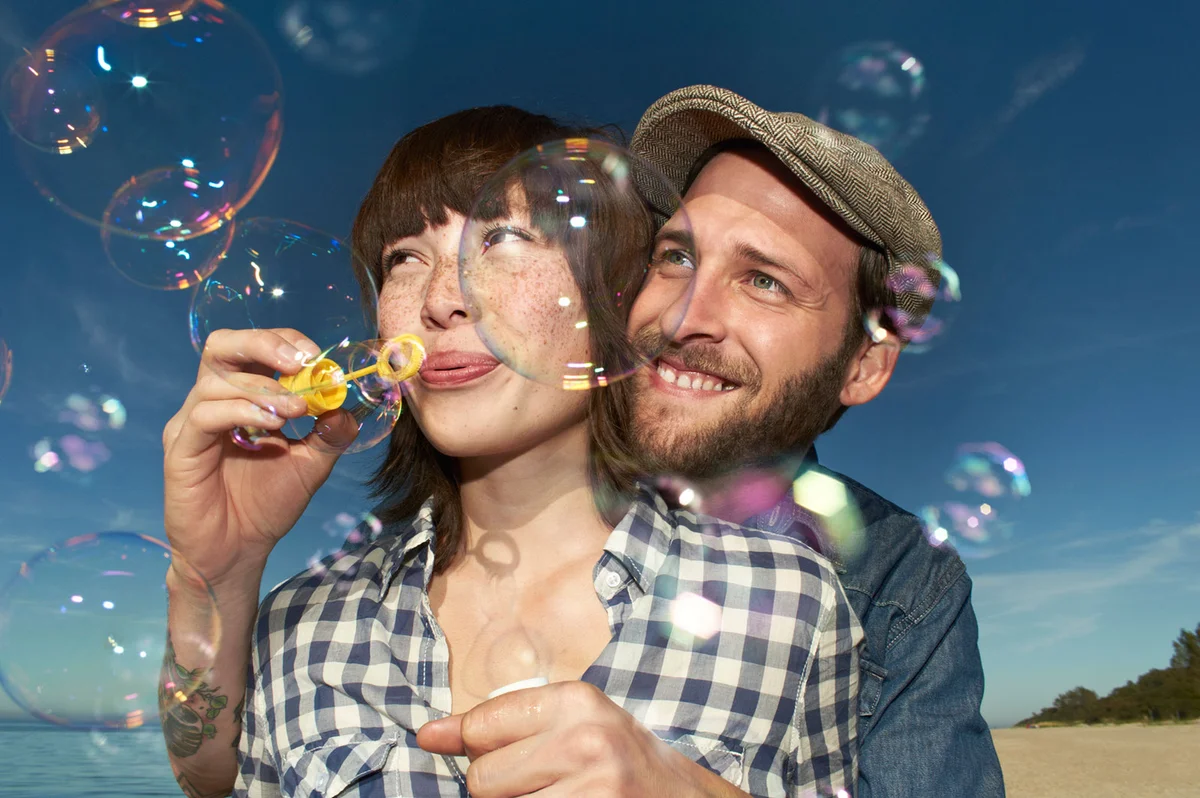 Couple blowing bubbles