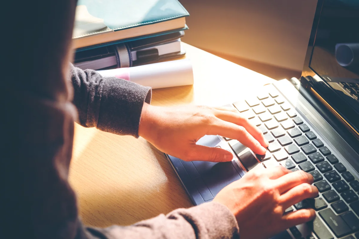 Typing on laptop