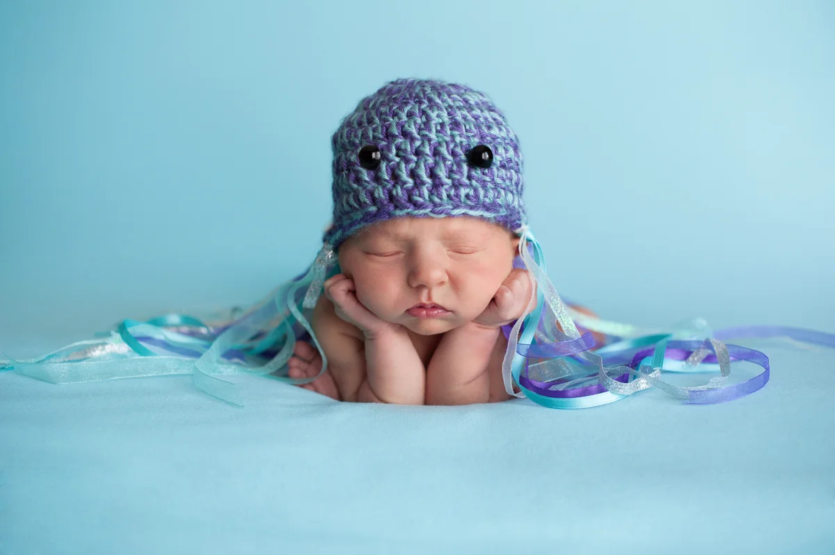 infant with jellyfish hat