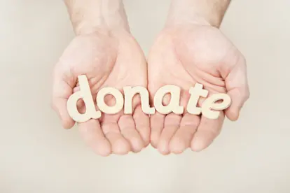 Hands holding donate letters