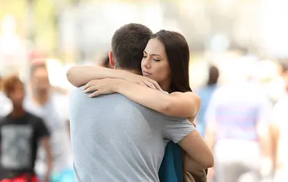 Couple with problems hugging on the street