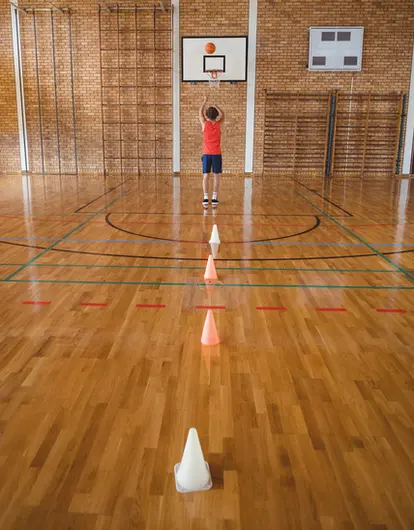 high school boy playing basketball