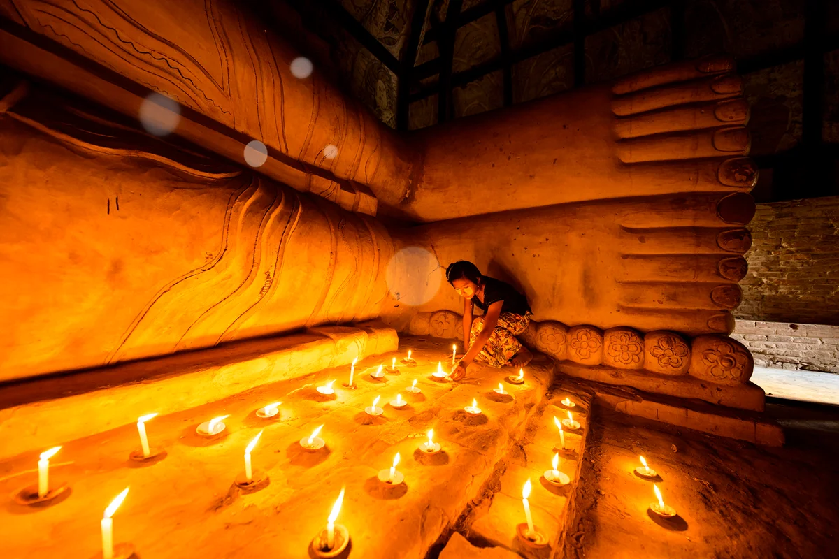 woman lighting candles white orbs
