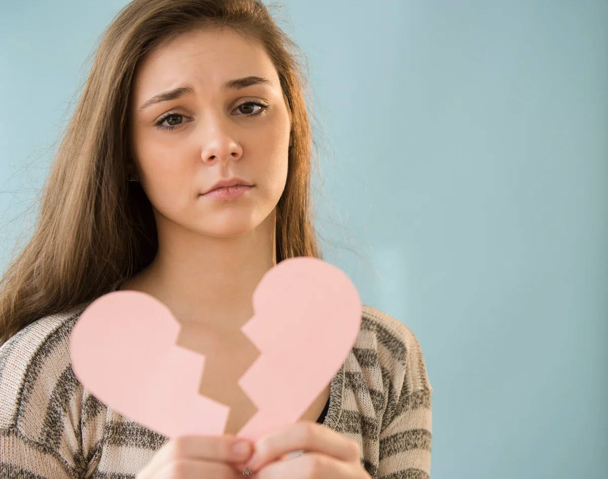 girl holding broken heart