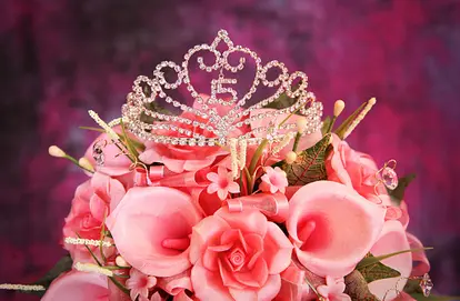 Quinceanera Crown on top of pink flowers