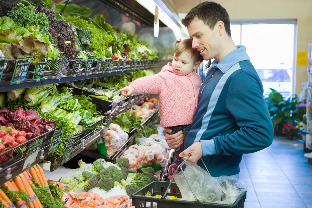 Man and baby girl in supermarket