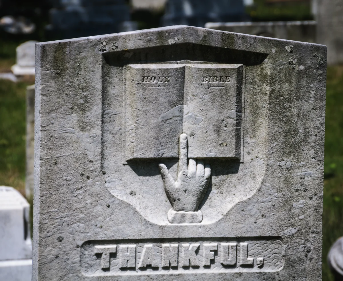 headstone with hand pointing up