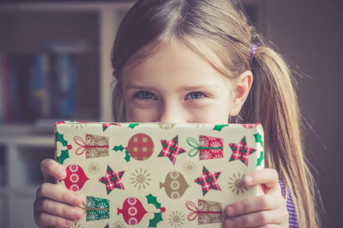 Little girl holding Christmas present