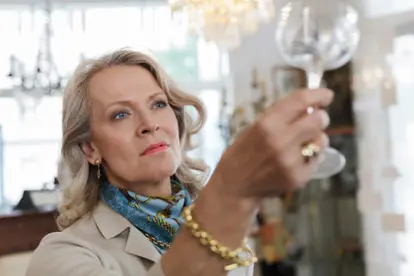 Woman examining antique glass