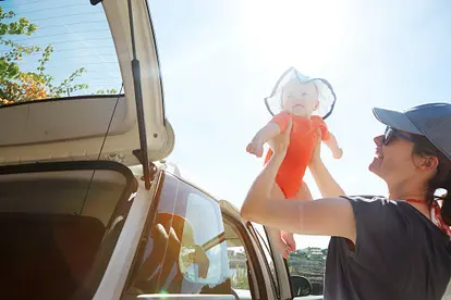 Mom taking baby out of car
