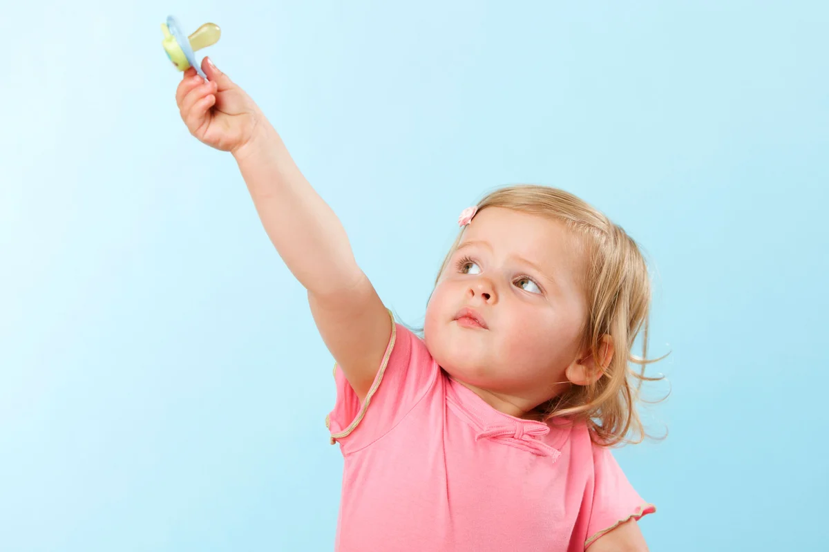 Girl giving up pacifier