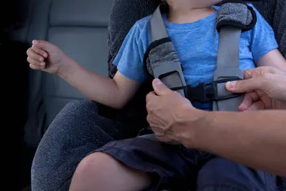Mother fastening child seat belt