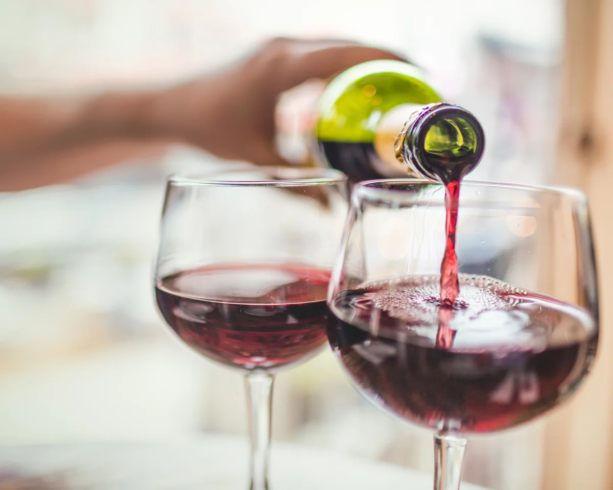 Pouring red wine in glasses
