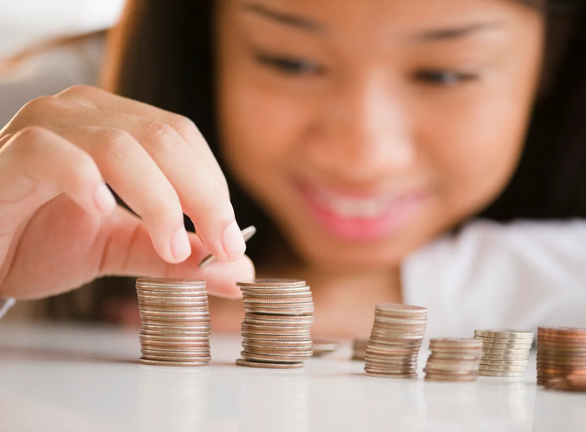 teenage girl stacking coins