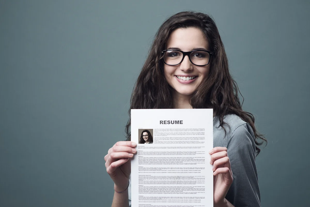 Young woman holding her resume