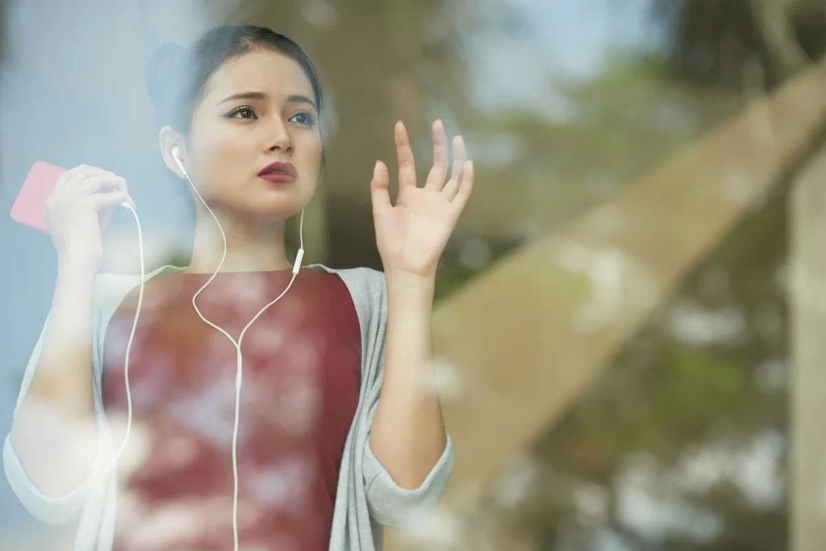 sad woman looking out window