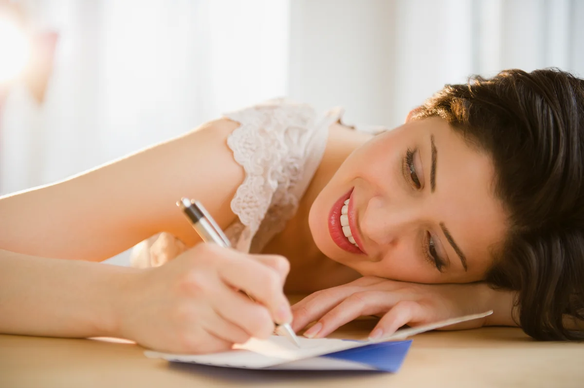 woman writing on wedding card